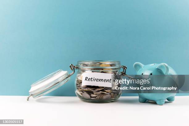 piggy bank and coin jar savings for retirement - retirement income stock pictures, royalty-free photos & images