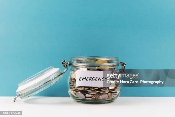 emergency fund coin jar - emergencies and disasters stock pictures, royalty-free photos & images