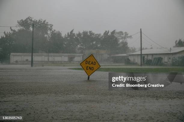 traffic sign in floodwater - flood warning stock pictures, royalty-free photos & images