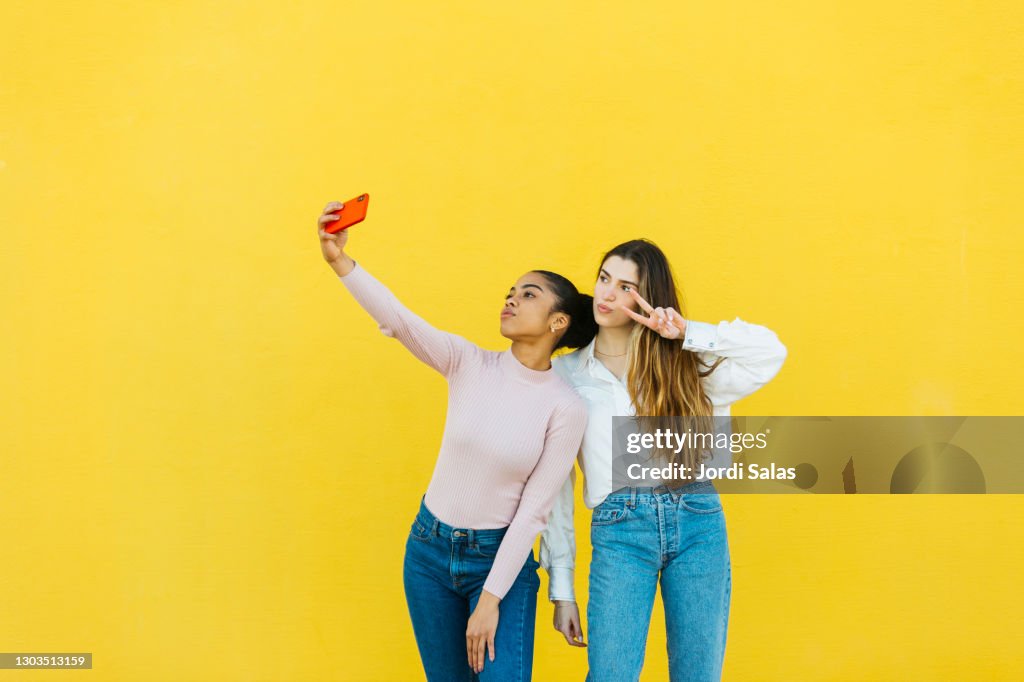 Portrait of two young girls taking a selfie