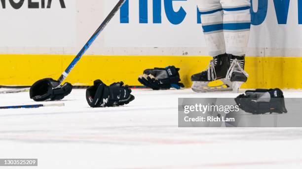 Gloves and sticks lay on the ice after players from the Vancouver Canucks and the Winnipeg Jets get tangled up after the whistler during NHL hockey...