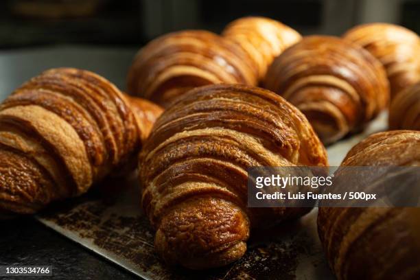 close-up of sweet food on table - croissant foto e immagini stock