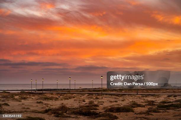 scenic view of beach against sky during sunset,castillo caleta de fuste,las palmas,spain - caleta de fuste stock-fotos und bilder