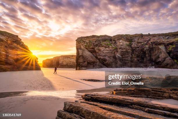 majestic bright sunrise in playa de las catedrales cathedral beach, galicia, spain - galicia stock pictures, royalty-free photos & images