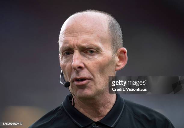 Referee Mike Dean during the Premier League match between Burnley and West Bromwich Albion at Turf Moor on February 20, 2021 in Burnley, United...