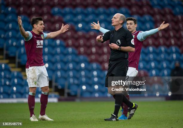 Matthew Lowton and Ashley Westwood of Burnley appeal to referee Mike Dean for a penalty during the Premier League match between Burnley and West...