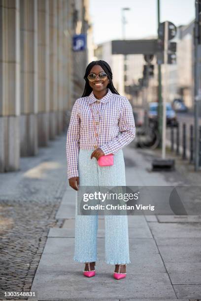 Lois Opoku is seen wearing pants and jacket Monki, Chanel micro bag in pink, Valentino heels on February 22, 2021 in Berlin, Germany.