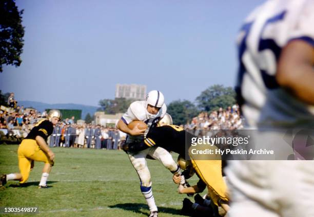Dave Kasperian of the Penn State Nittany Lions gets tackled during an NCAA game against the Army Cadets on October 4, 1958 at Michie Stadium in West...