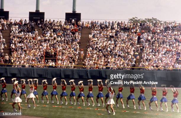Cheerleaders perform on the field prior to an MLB game between the Pittsburgh Pirates and the Milwaukee Braves on July 4, 1960 at Milwaukee County...