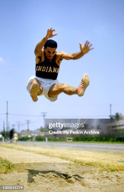 Greg Bell of the University of Indiana Hoosiers participates in the long jump event during the 1956 Olympic Track & Field Trials circa June, 1956 in...