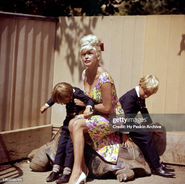 American film, theatre, and television actress Jayne Mansfield poses for a portrait with her sons Miklos Hargitay and Zoltan Hargitay as they sit on...