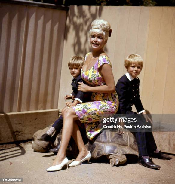 American film, theatre, and television actress Jayne Mansfield poses for a portrait with her sons Miklos Hargitay and Zoltan Hargitay as they sit on...