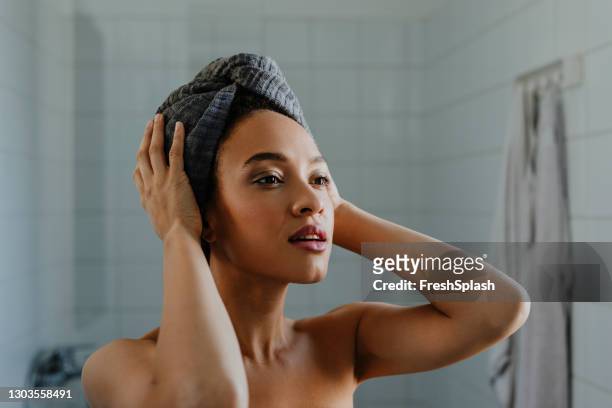 portrait of a beautiful afro woman who's just washed her hair - towel stock pictures, royalty-free photos & images