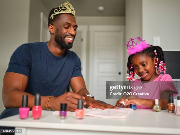 dad and daughter playing together and painting fingernails - african american nails stock pictures, royalty-free photos & images