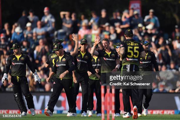 Daniel Sams of Australia is congratulated by team mates after dismissing Kane Williamson of New Zealand during game one of the Men's International...
