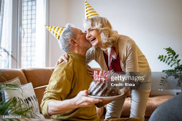 senior couple at home, celebrating birthday - senior birthday stock pictures, royalty-free photos & images