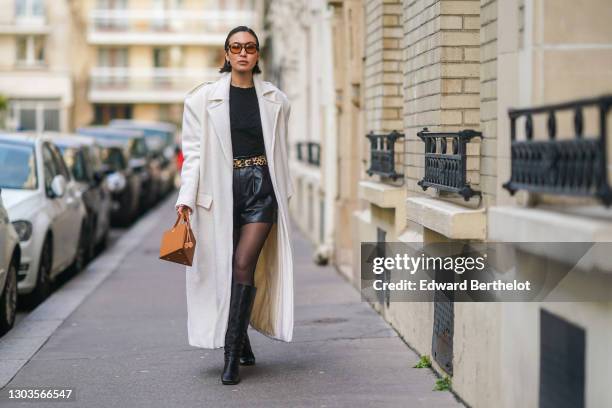 Yoshino Mia wears brown clear sunglasses from Vehla eyewear, a white long wool trench coat designed by herself, a black texture top from Klei Studio,...