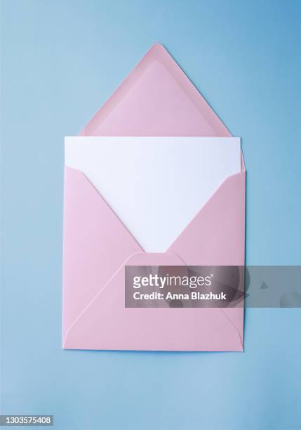 pink envelope with white blank paper card over blue background - greeting card and envelope stock pictures, royalty-free photos & images
