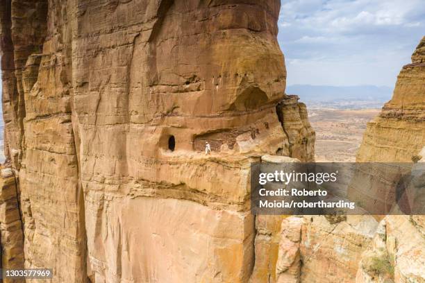 aerial view of opening carved in rocks, entrance of abuna yemata guh church, gheralta mountains, tigray region, ethiopia, africa - abuna yemata guh church stockfoto's en -beelden