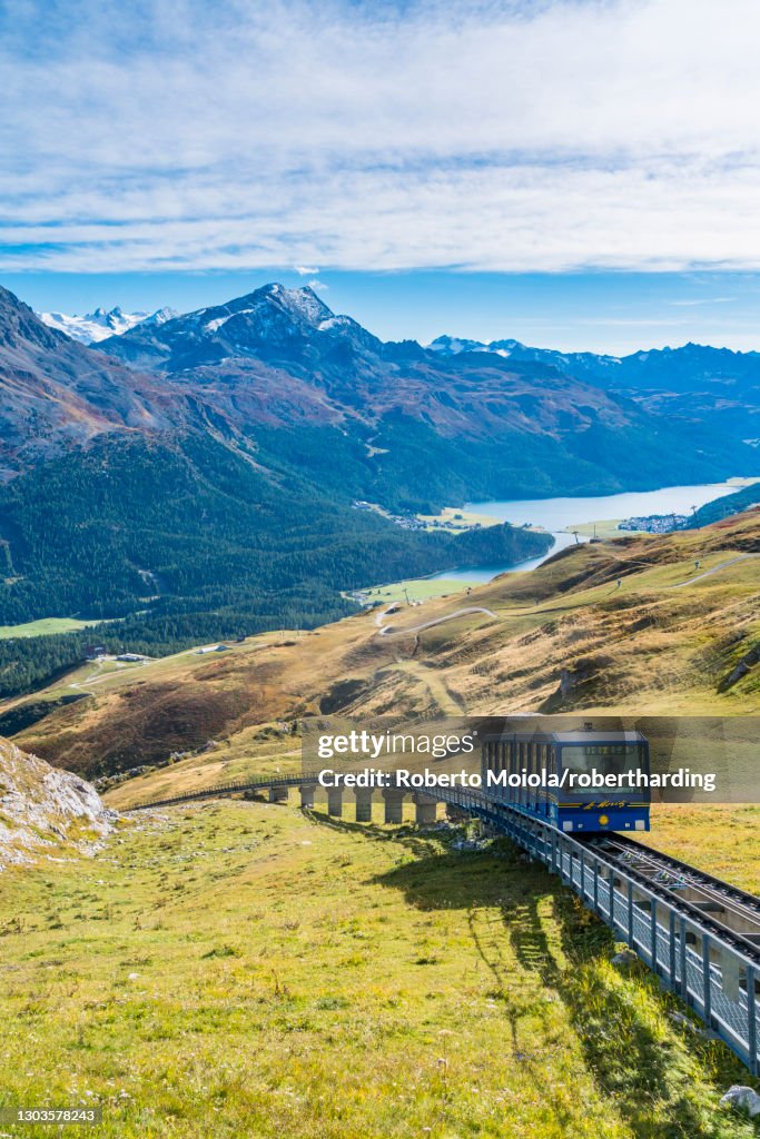Chantarella-Corviglia funicular traveling uphill with St. Moritz lake in background, Engadine, canton of Graubunden, Switzerland, Europe