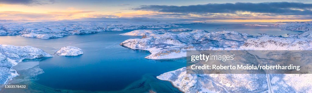 Arctic sunrise over the frozen sea and mountains covered with snow, Laksefjorden, Lebesby, Kunes, Troms og Finnmark, Norway, Scandinavia, Europe