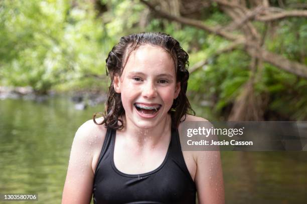 teenage girl laughing by river - australasia stock pictures, royalty-free photos & images