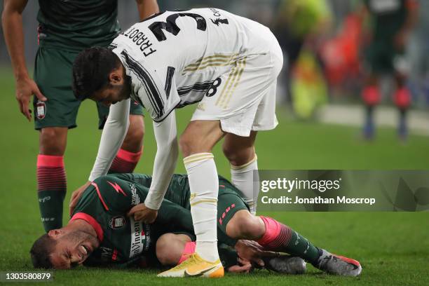 Gianluca Frabotta of Juventus checks on Andrea Rispoli of Crotone after making a late challenge that would earn him a yellow card during the Serie A...