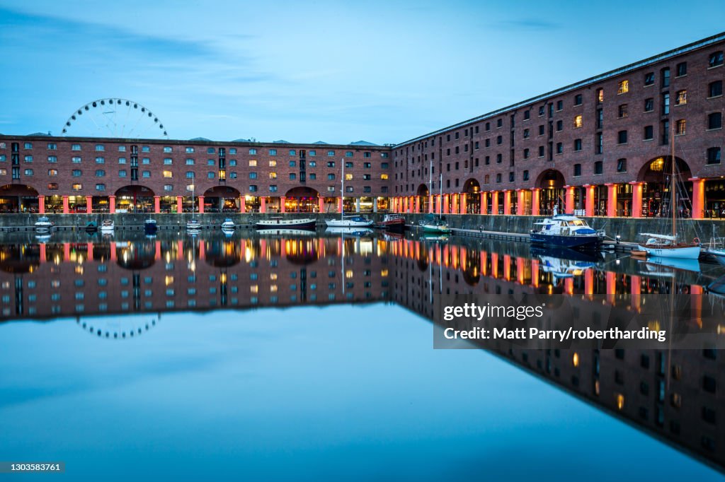 The Wheel of Liverpool seen behind the Albert Dock on the River Mersey waterfront, UNESCO World Heritage Site, during the evening twilight (blue hour), Liverpool, Merseyside, England, United Kingdom, Europe