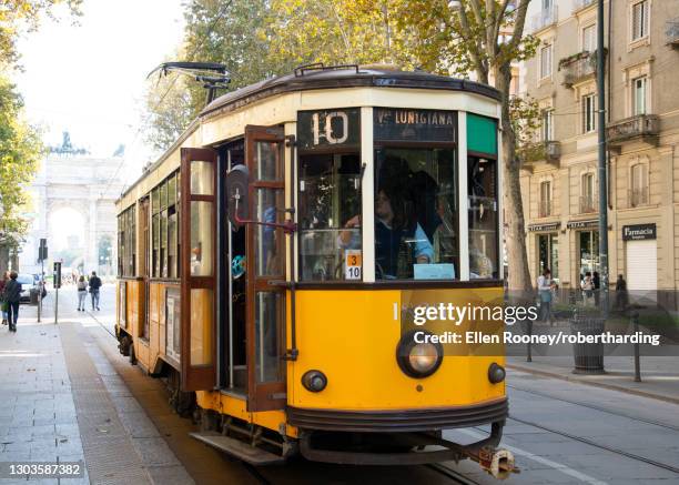 a 1920s yellow electric tram in central milan, lombardy, italy, europe - milan tram stock pictures, royalty-free photos & images