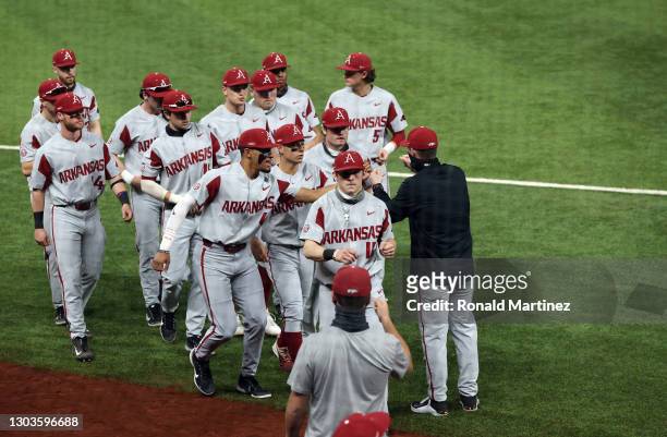 The Arkansas Razorbacks run on the field before a game against the TCU Horned Frogs during the 2021 State Farm College Baseball Showdown at Globe...