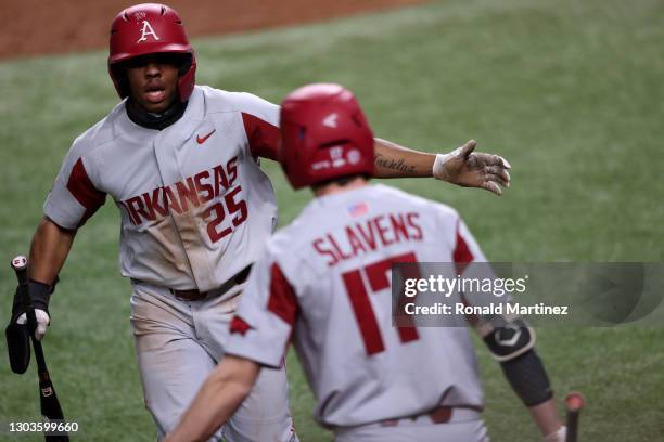 Christian Franklin and Brady Slavens of the Arkansas Razorbacks celebrate a run against the TCU Horned Frogs in the eighth inning during the 2021...