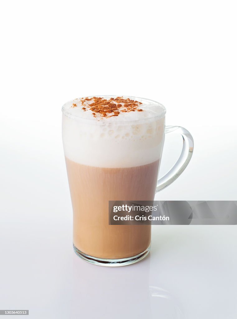 Glass of cappuccino on white background