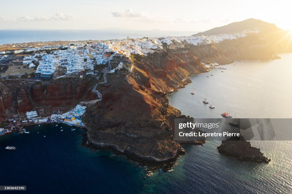 Oia (and Amoudi bay) at sunrise from de sky, Santorini, Greece
