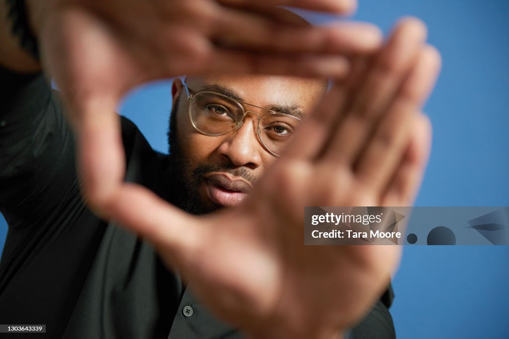 Young making looking through hands