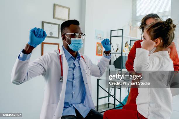 young girl at a pediatric office - protective face mask happy stock pictures, royalty-free photos & images