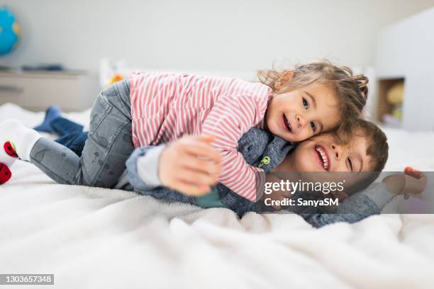 playful brother and sister - two boys in bed stock pictures, royalty-free photos & images