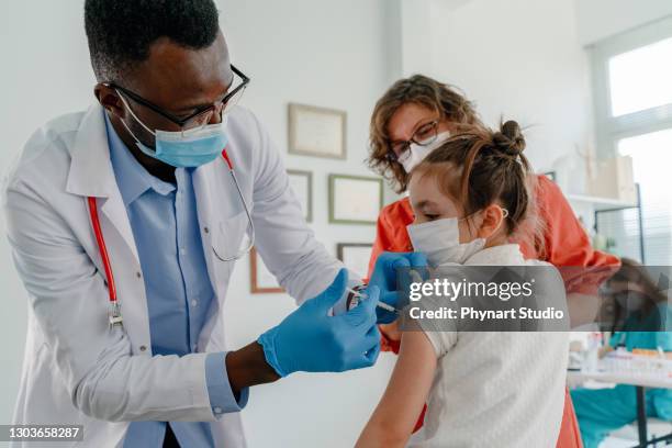 little girl getting vaccinated - covid 19 vaccine united states stock pictures, royalty-free photos & images