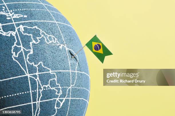 a world globe with a brazilian flag pin showing brazil - brazilian flag foto e immagini stock