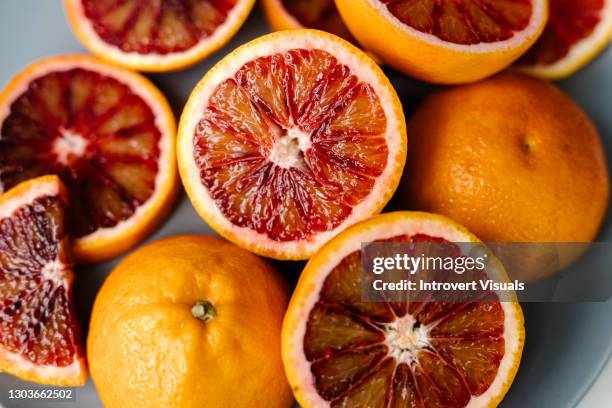 healthy lifestyle bloody oranges background halves - blood orange stock pictures, royalty-free photos & images