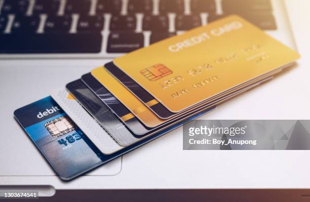 group of debit card and credit card on laptop. - credit card and stapel stockfoto's en -beelden