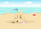 Sandcastle on beach flat color vector illustration. Summer vacation entertainment for kids. Sand castle and children toys on seacoast 2D cartoon landscape with water on background