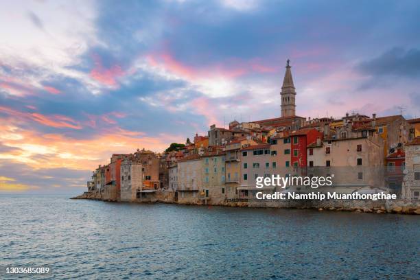 beautiful scenery of rovinj located in croatia shows the colorful sky of beautiful city near shore. - rovinj stock pictures, royalty-free photos & images