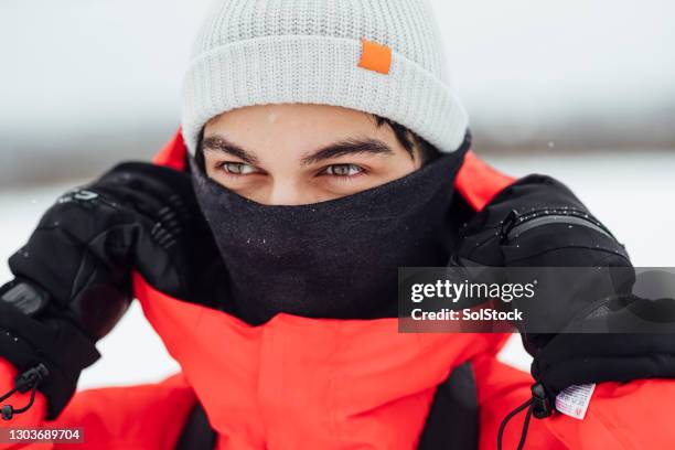 young man wrapped up against the cold - neck gaiter stock pictures, royalty-free photos & images