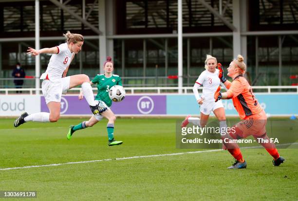 Ellen White of England shoots under pressure from Rebecca Flaherty of Northern Ireland during the Women's International Friendly match between...