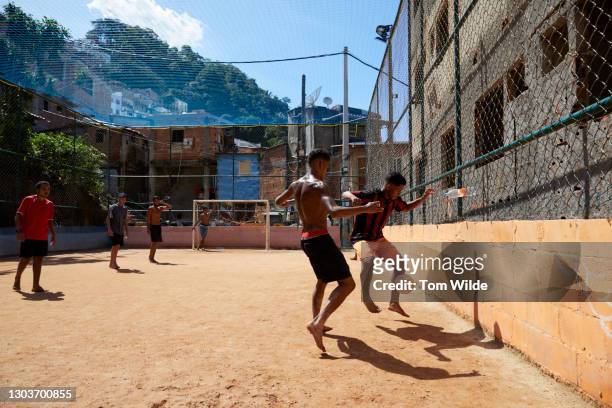 five young men playing soccer on a clay court - brazilian playing football bildbanksfoton och bilder