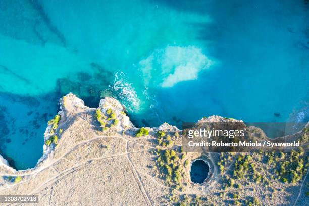sea cave and crystal sea from above, salento, italy - crystal caves stock-fotos und bilder