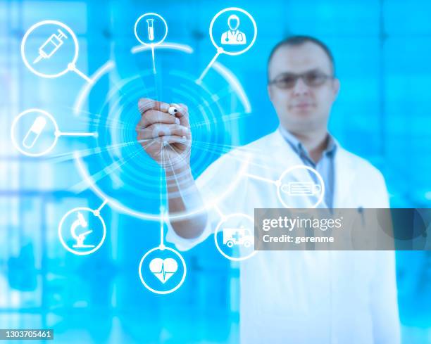 doctor writing on transparent board - transparent wipe board stock pictures, royalty-free photos & images