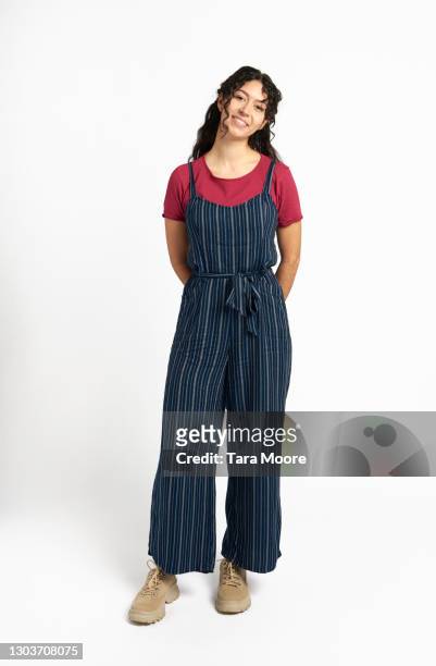 young woman standing looking to camera - bib overalls 個照片及圖片檔