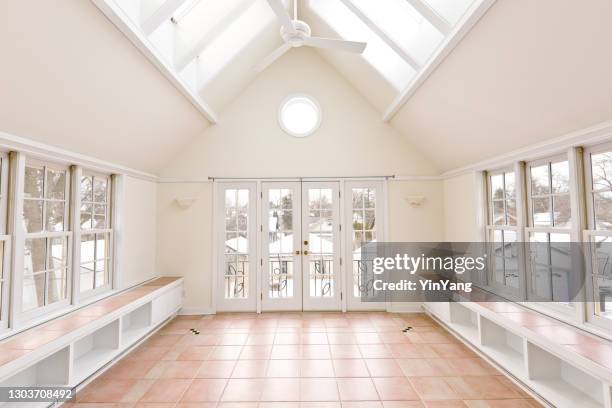 a residential home featuring a solarium sun room with skylights, wrap around window and french doors - french doors stock pictures, royalty-free photos & images