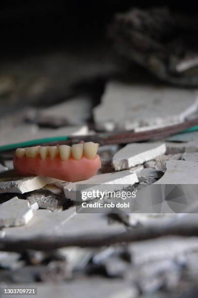 dentures inside abandoned mental asylum - dentures stock pictures, royalty-free photos & images